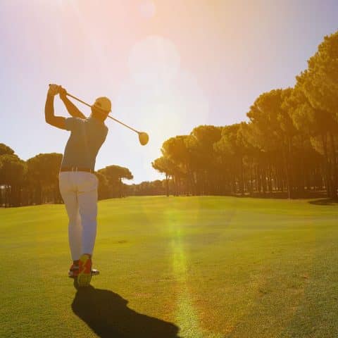 golfer teeing off