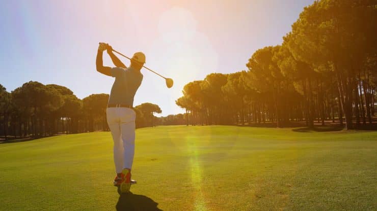 golfer teeing off
